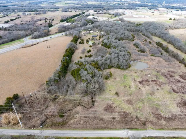 a view of a yard with wooden fence