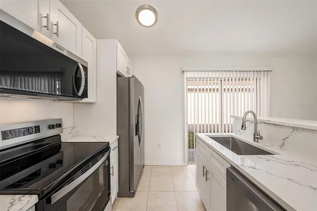 a kitchen with a sink stove and microwave
