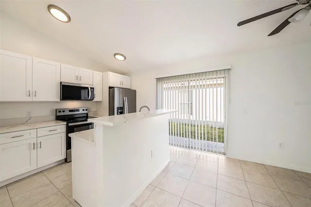 a kitchen with stainless steel appliances a refrigerator sink and microwave