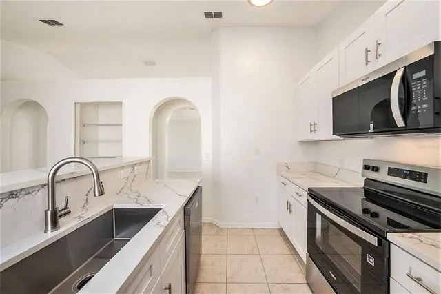 a kitchen with a sink and stainless steel appliances
