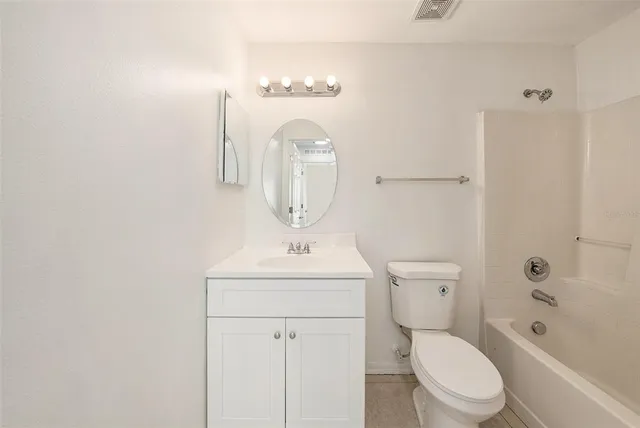 a bathroom with a toilet a sink and a mirror