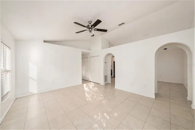 a view of a livingroom with a ceiling fan and entryway