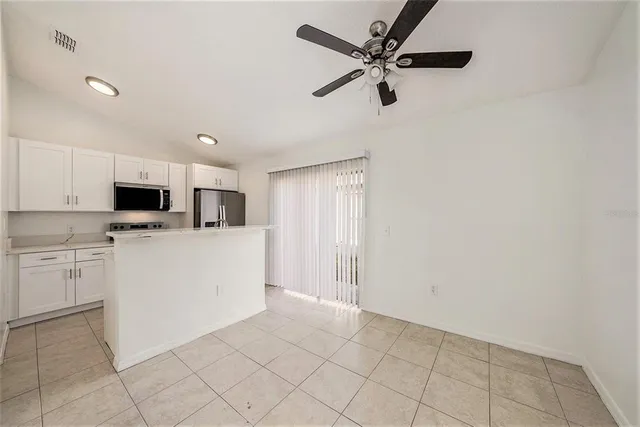 a view of kitchen with appliances and cabinets
