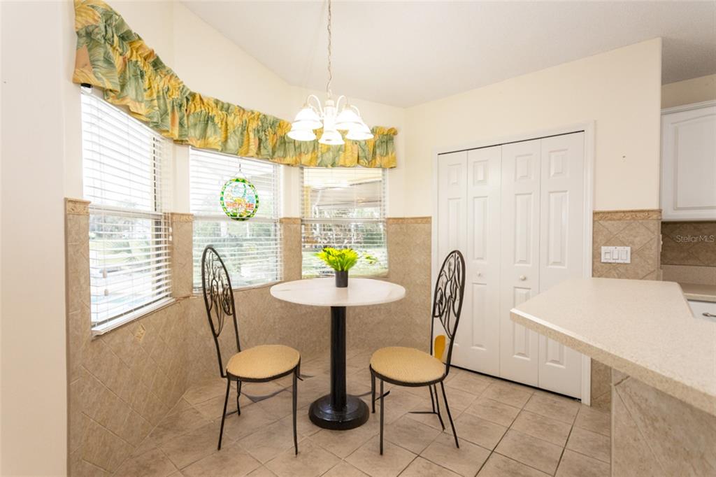 21 Comanche Court Palm Coast, FL 32137 - Photo 15 of 50 a view of a dining room with furniture and a chandelier