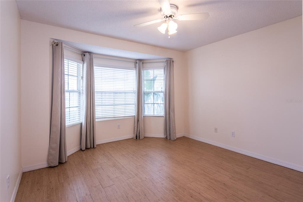 21 Comanche Court Palm Coast, FL 32137 - Photo 29 of 50 an empty room with wooden floor fan and windows
