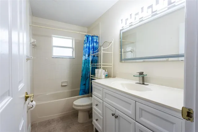 a view of a house with swimming pool and sitting area