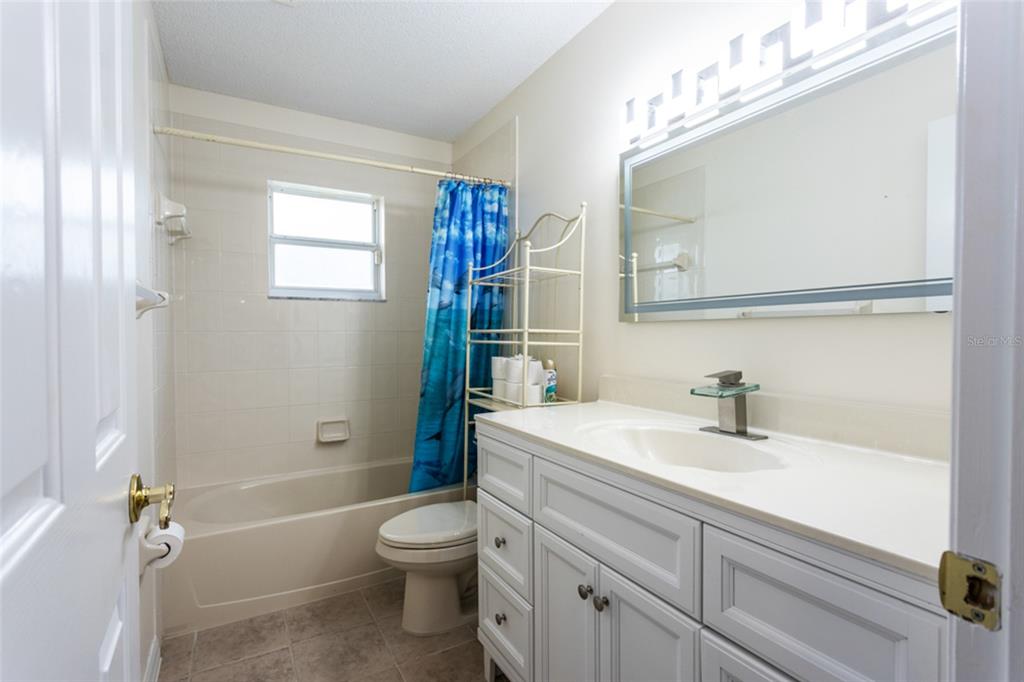 21 Comanche Court Palm Coast, FL 32137 - Photo 32 of 50 a bathroom with a sink a toilet and shower