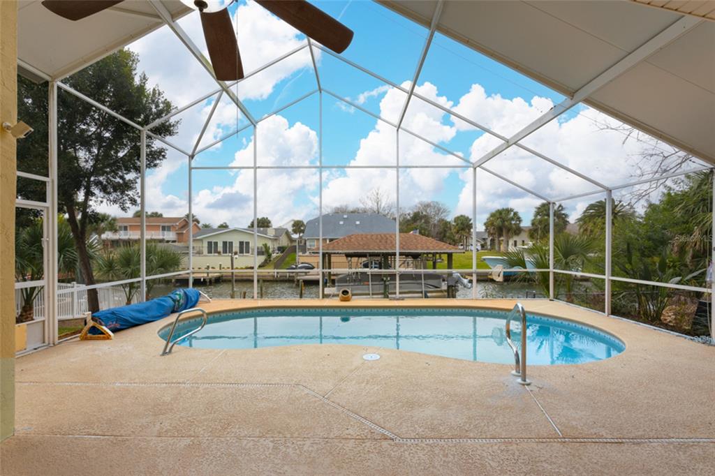21 Comanche Court Palm Coast, FL 32137 - Photo 38 of 50 a view of a swimming pool with a lounge chairs