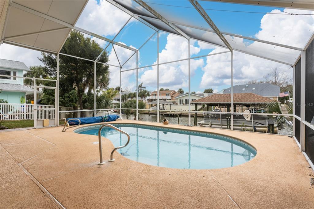 21 Comanche Court Palm Coast, FL 32137 - Photo 39 of 50 a view of a swimming pool with a porch