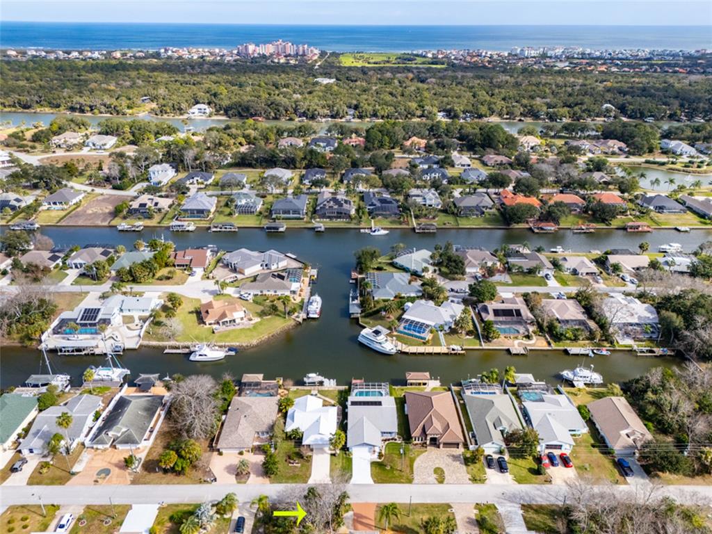 21 Comanche Court Palm Coast, FL 32137 - Photo 45 of 50 an aerial view of a city with lots of residential buildings ocean and mountain view in back