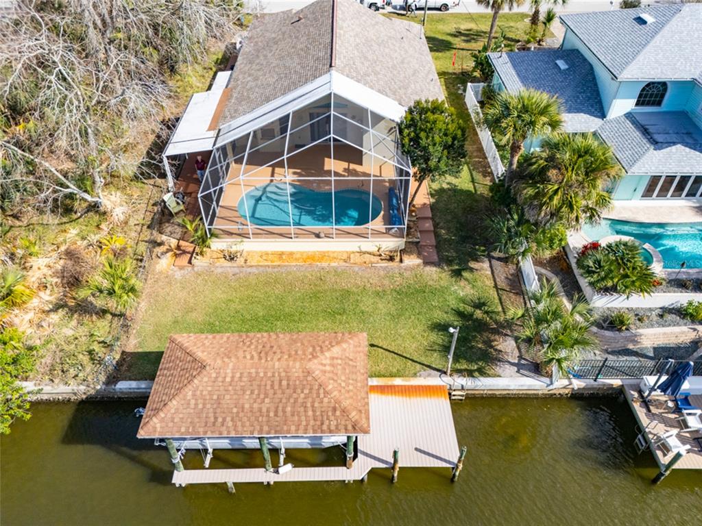21 Comanche Court Palm Coast, FL 32137 - Photo 47 of 50 a aerial view of a house with swimming pool and large trees