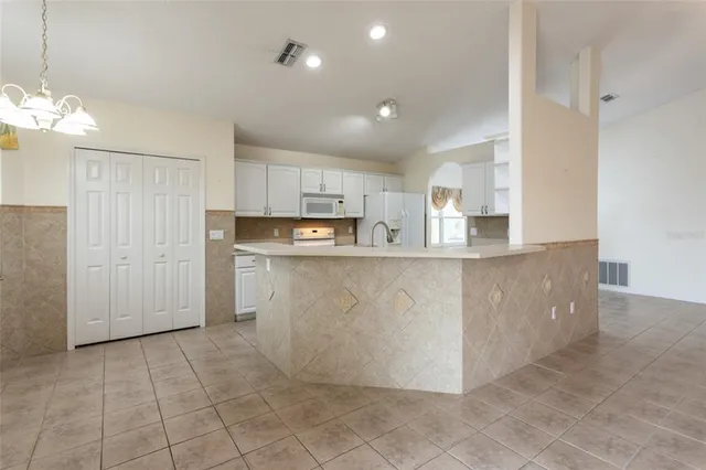 a kitchen with stainless steel appliances granite countertop a sink a stove and cabinets