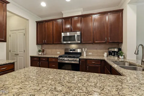 a living room with furniture and kitchen view