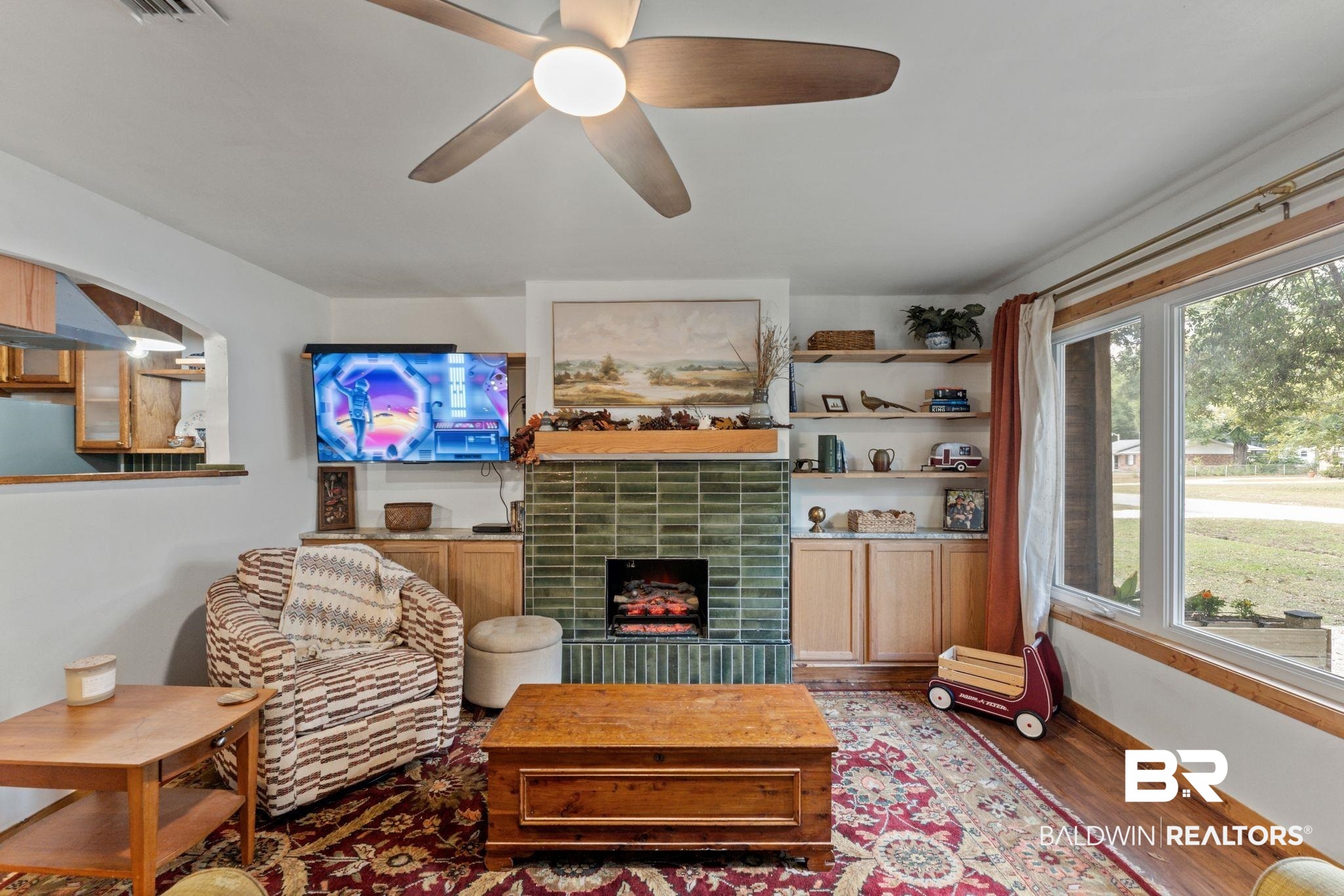 10785 Gregg Road Semmes, AL 36575 - Photo 2 of 35 Living area with wood finished floors, a tiled fireplace, and a ceiling fan