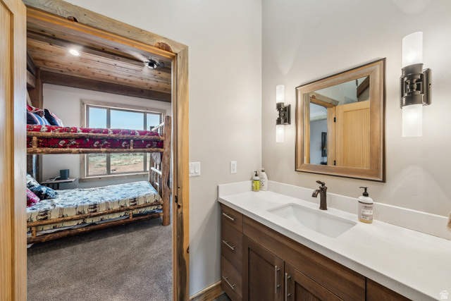 46997 West Thunder Road Fruitland, UT 84027 - Photo 19 of 49 Ensuite bathroom with vanity, dark colored carpet, and wood ceiling