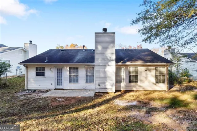 a view of a brick house with a yard