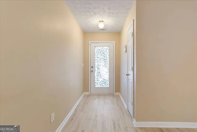 a view of entryway with wooden floor