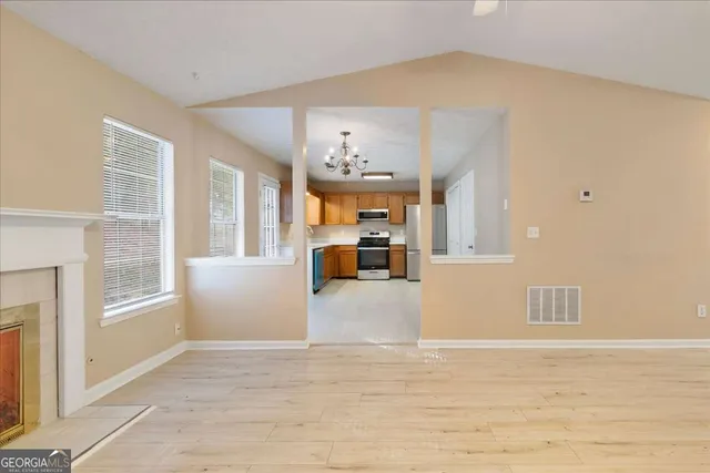 a view of a living room a kitchen with furniture and window