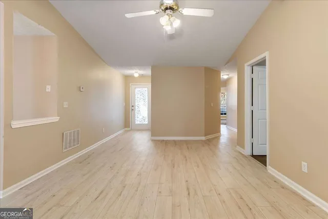 wooden floor in an empty room with a window