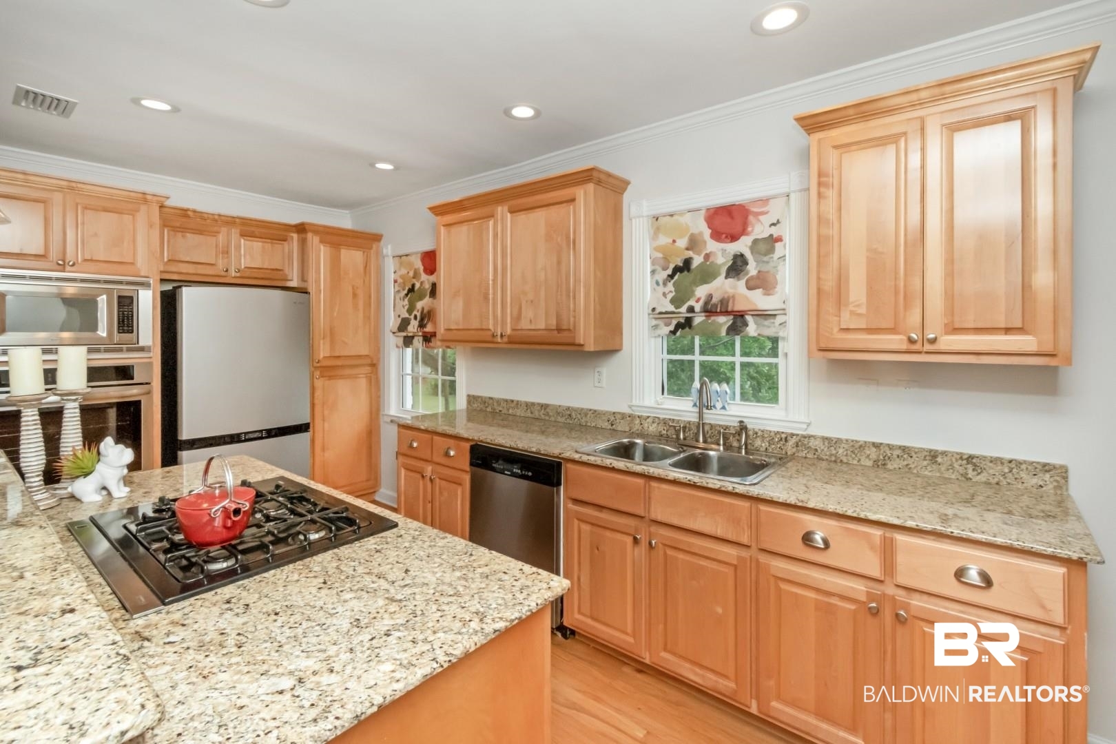 214 Upham Street, Unit 3D Mobile, AL 36607 - Photo 10 of 34 Kitchen with stainless steel appliances, light stone counters, light wood-style floors, crown molding, and light wood finish cabinetry