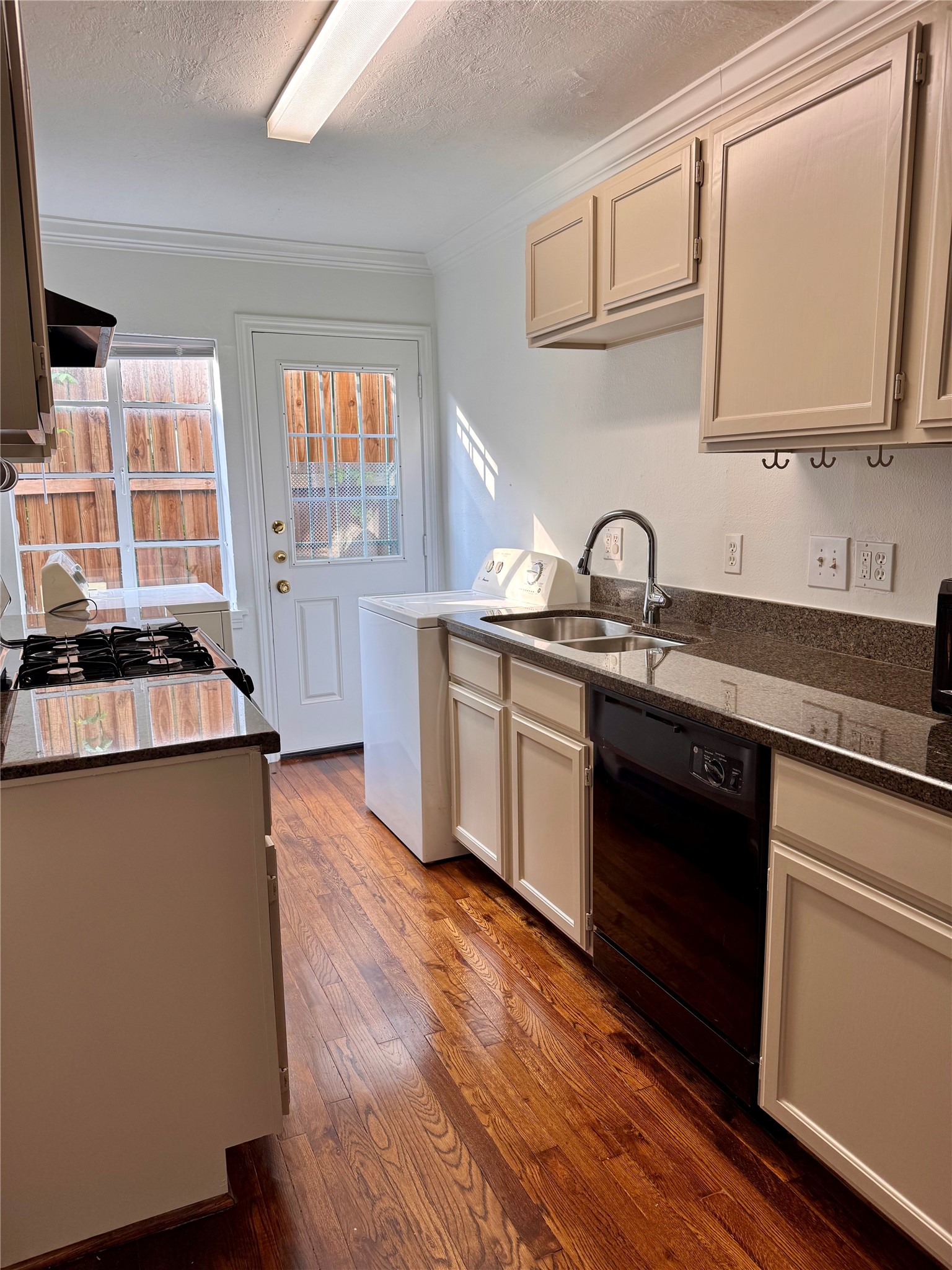 2646 Persa Street, Unit 1 Houston, TX 77098 - Photo 11 of 14 a kitchen with granite countertop a sink cabinets and stainless steel appliances