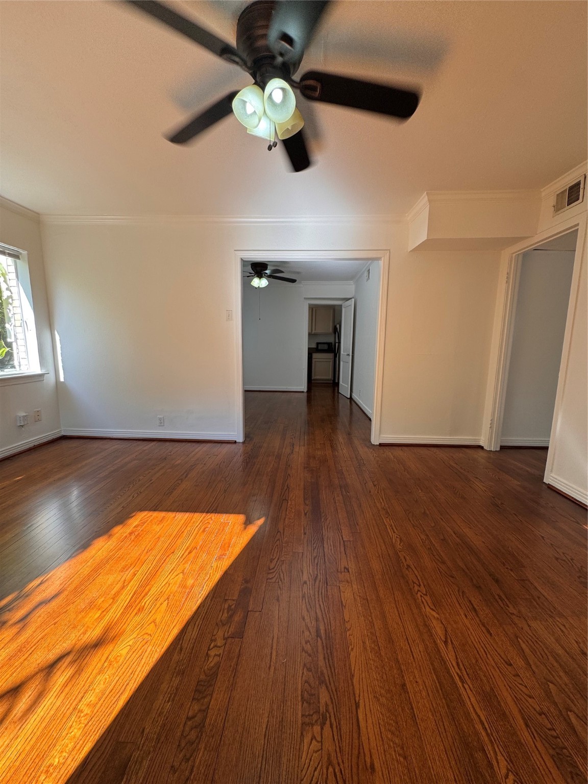 2646 Persa Street, Unit 1 Houston, TX 77098 - Photo 13 of 14 a view of an empty room with wooden floor and a ceiling fan