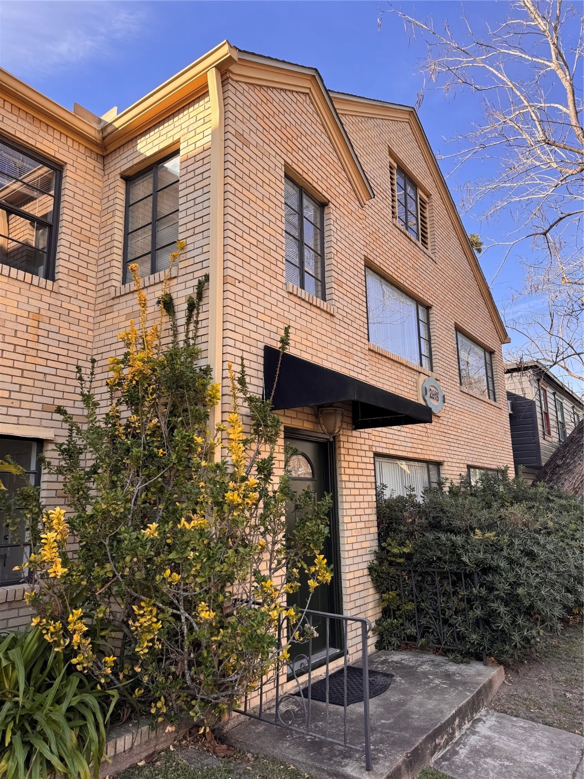 2646 Persa Street, Unit 1 Houston, TX 77098 - Photo 14 of 14 a front view of a house with garden