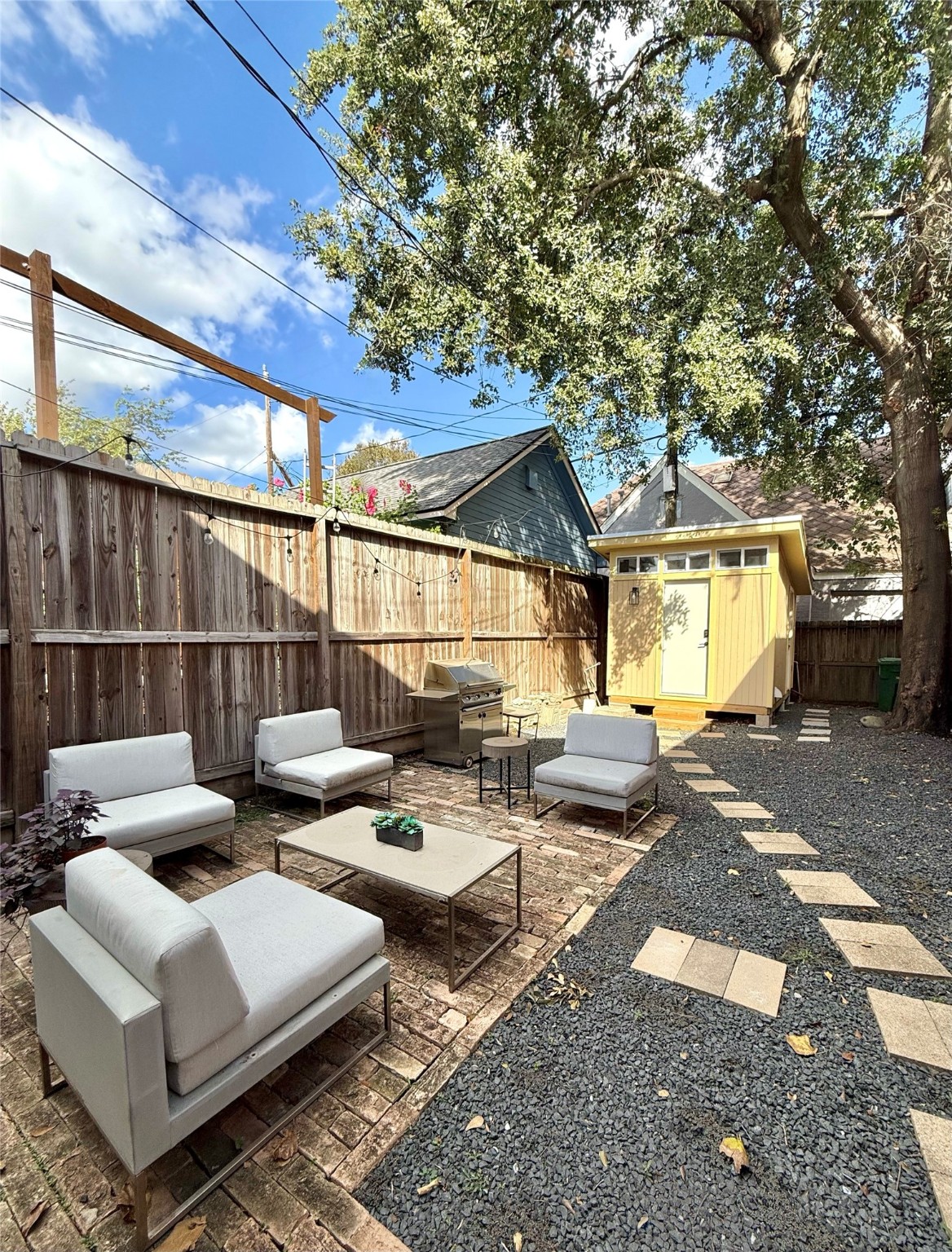 2646 Persa Street, Unit 1 Houston, TX 77098 - Photo 2 of 14 a view of a patio with couches table and chairs and potted plants