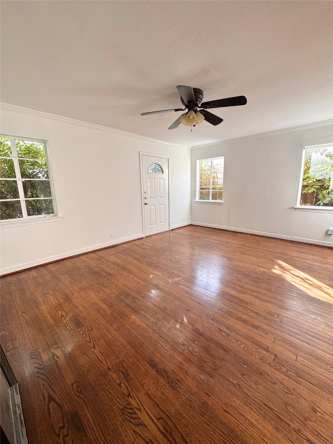 2646 Persa Street, Unit 1 Houston, TX 77098 - Photo 5 of 14 a view of an empty room with wooden floor and a window