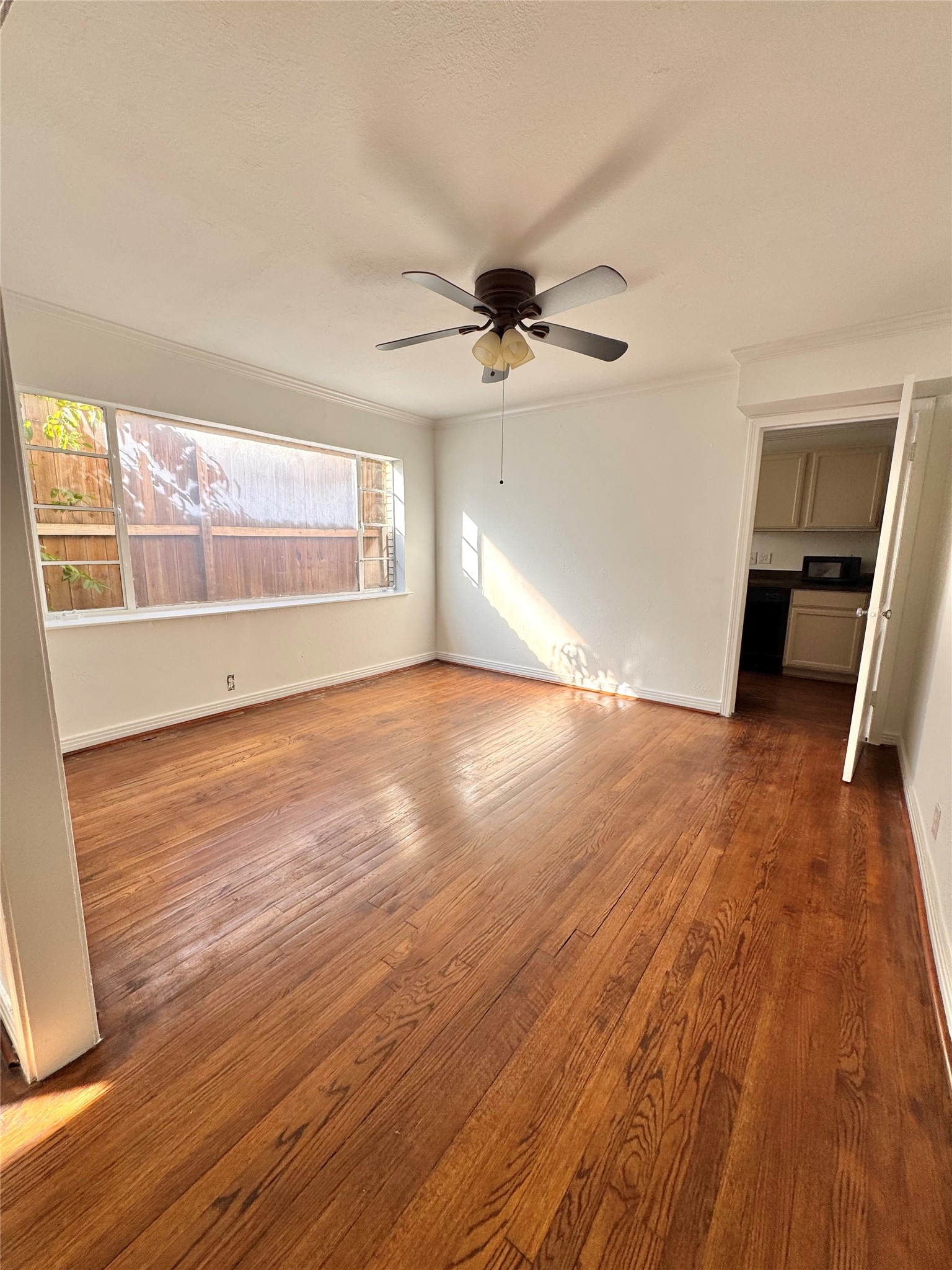2646 Persa Street, Unit 1 Houston, TX 77098 - Photo 6 of 14 wooden floor in an empty room with a window