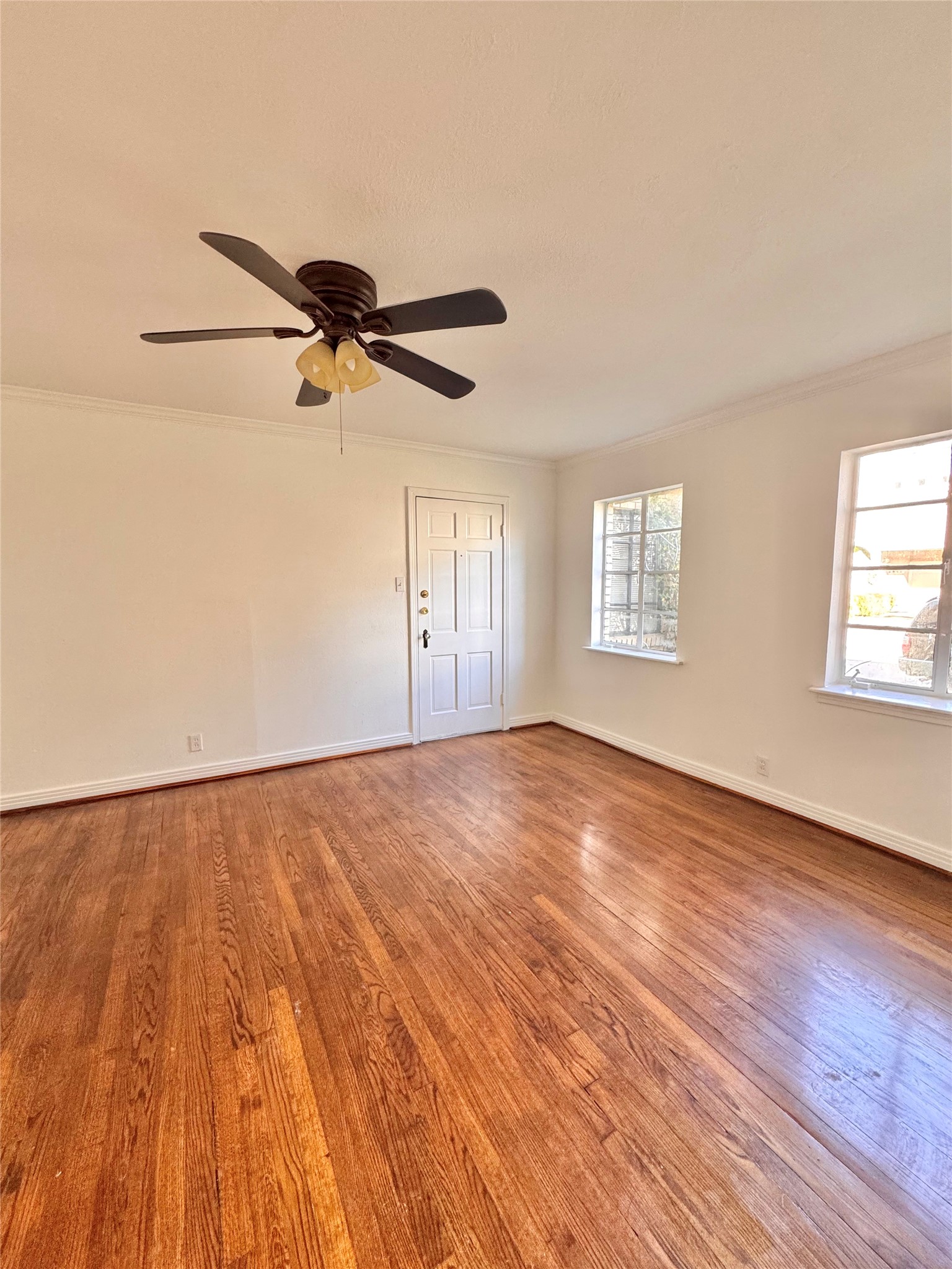 2646 Persa Street, Unit 1 Houston, TX 77098 - Photo 7 of 14 an empty room with wooden floor fan and windows
