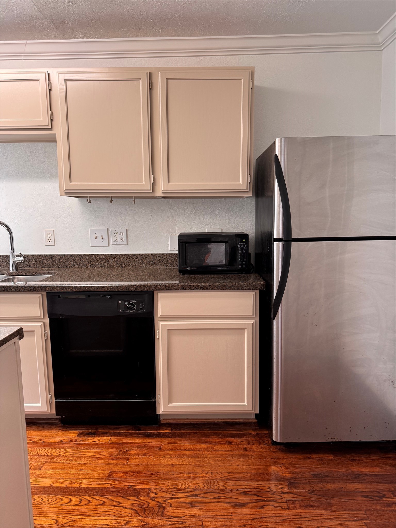 2646 Persa Street, Unit 1 Houston, TX 77098 - Photo 10 of 14 a kitchen with granite countertop a refrigerator sink and cabinets