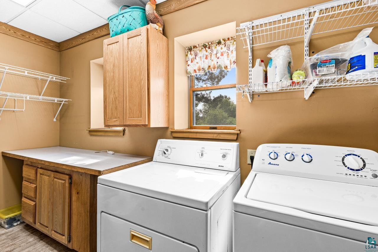 4800 Tower Road Moose Lake, MN 55767 - Photo 63 of 83 Dedicated utility space featuring a built-in countertop, wood cabinetry, and a window