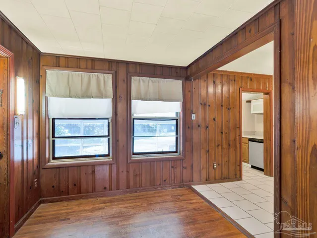 an empty room with windows and closet