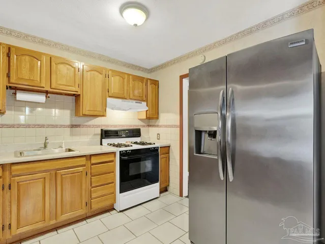 a kitchen with cabinets stainless steel appliances and a counter