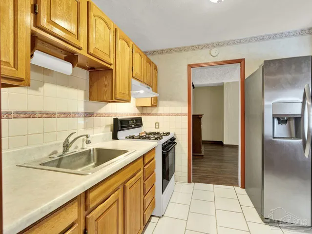 a kitchen with a sink and a refrigerator