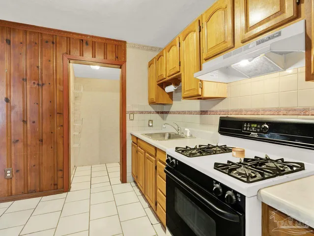 a kitchen with a stove and a sink