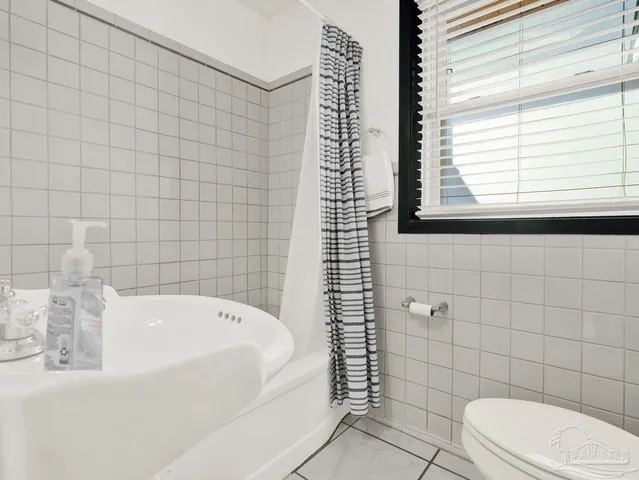 a bathroom with a bathtub and window