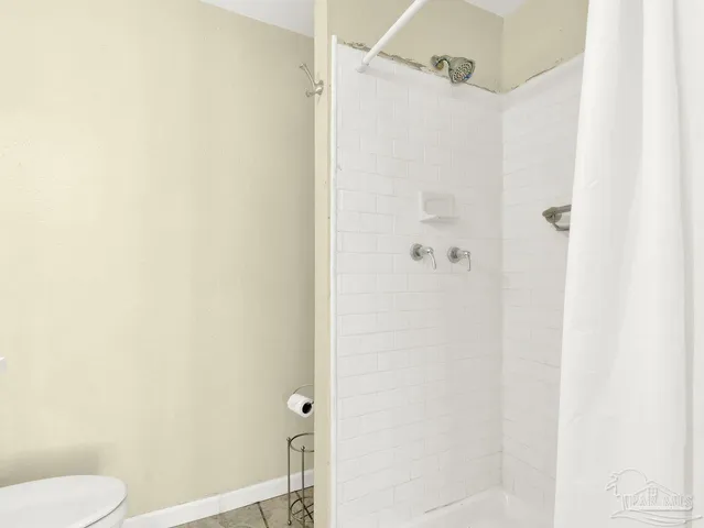a bathroom with a shower and toilet