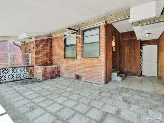 a view of a brick house with many windows