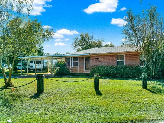 a view of a house with a yard porch and sitting area