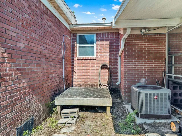 a brick house with a sink and table in front of it