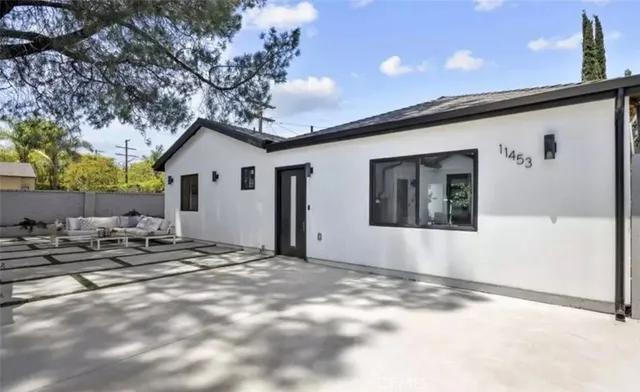 a view of a house with a tree