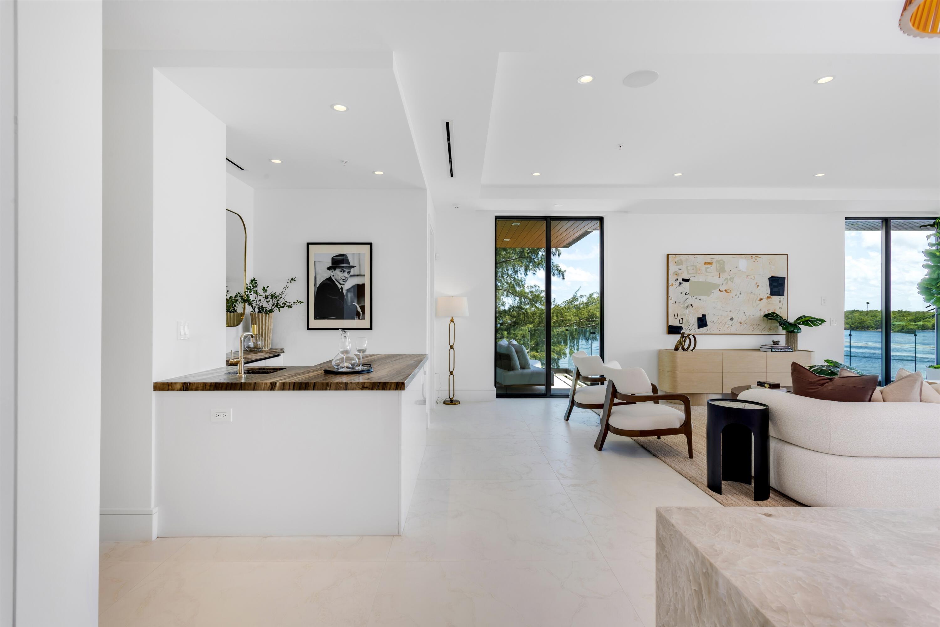 900 Lago Mar Lane, Unit PH Boca Raton, FL 33431 - Photo 8 of 58 a living room with furniture and view of kitchen