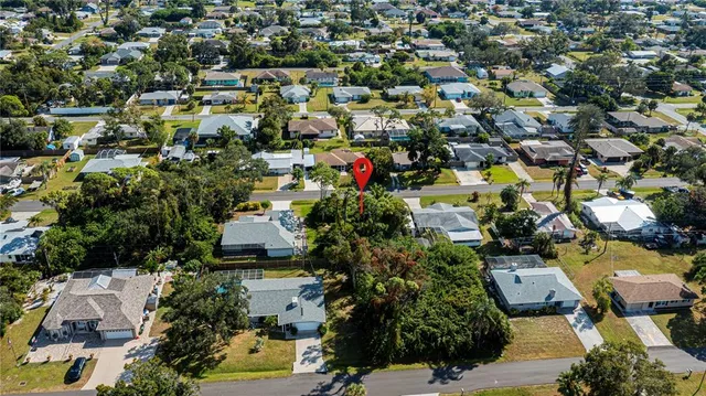 an aerial view of multiple houses with yard