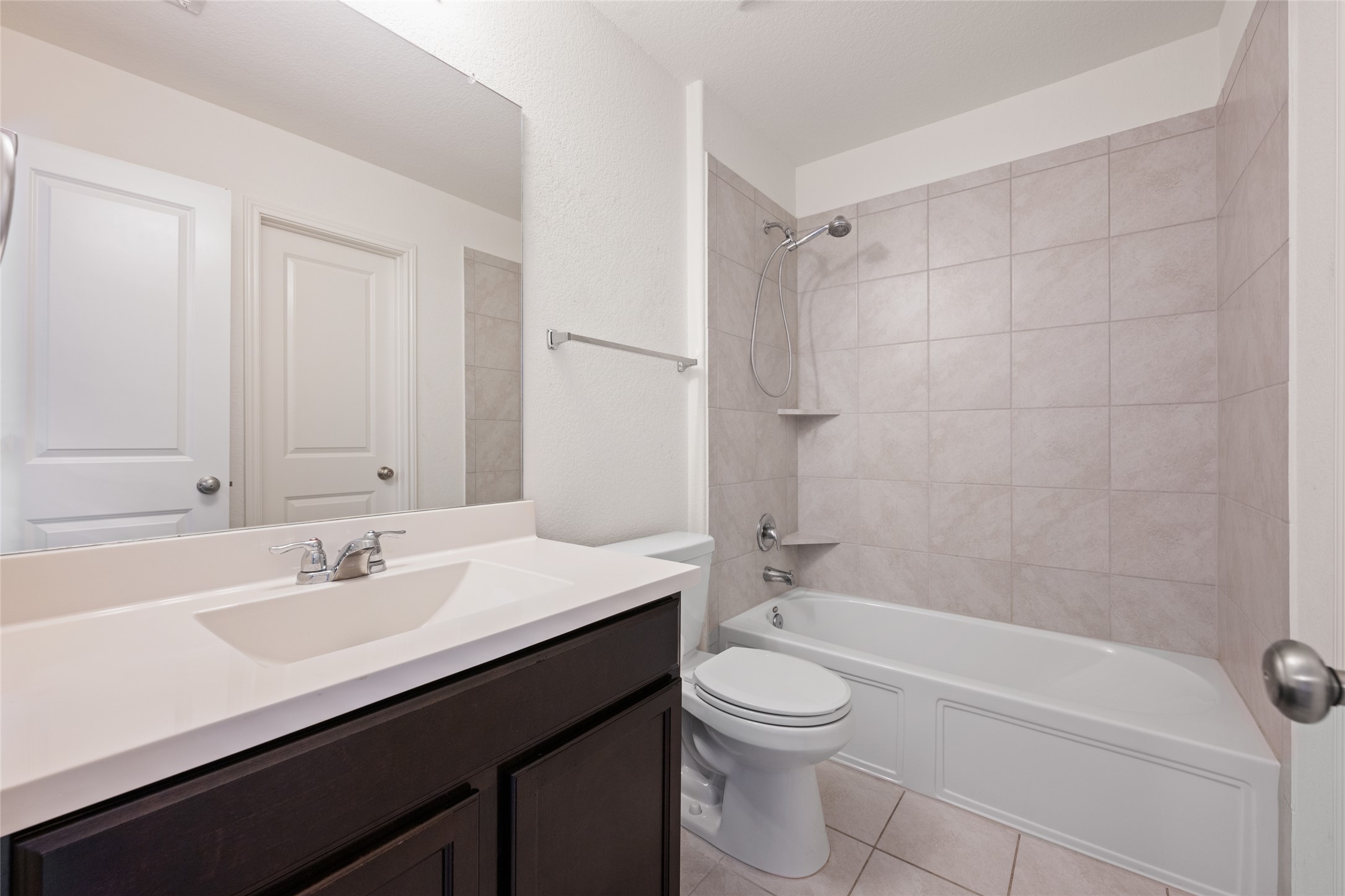 524 Circle Way, Unit 12F Jarrell, TX 76537 - Photo 28 of 34 Bathroom featuring vanity, shower / tub combination, and light tile patterned flooring
