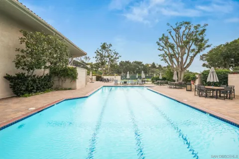 a view of swimming pool with outdoor seating and plants