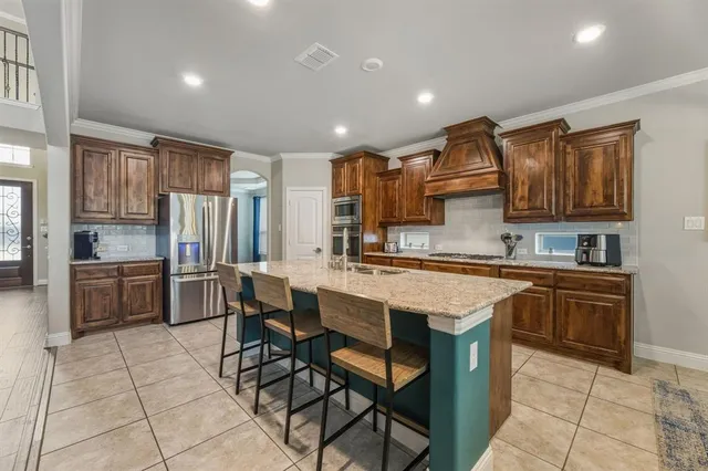 a kitchen with granite countertop a sink counter top space appliances and cabinets