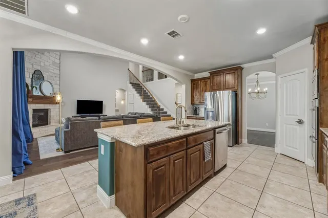 a kitchen with a stove a refrigerator and a sink
