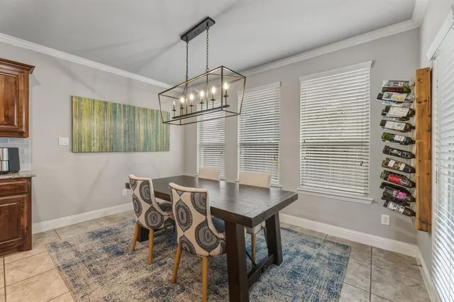 a view of a dining room with furniture and chandelier
